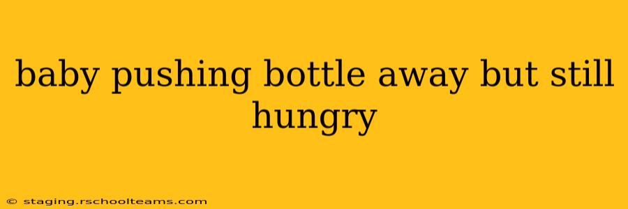 baby pushing bottle away but still hungry